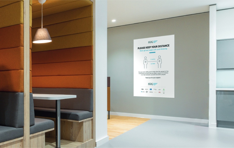Office hallway displaying social distancing guidelines for safe coworking.